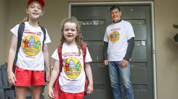 Long-time supporter of National Walk Safely to School Day and Olympian Peter Hadfield with his granddaughters Evie, 9, and Lola, 5, ahead of the event. Picture by John Veage
