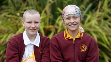 Yowie Bay Public School Year 6 students and best friends Chloe McKenzie-Matterson and Tirion Wilkinson. Chloe shaved her head in support of Tirion, who is battling stage 4 cancer. With the support of not only her community but Australia, Chloe raised more than $190,000. Picture by Chris Lane
