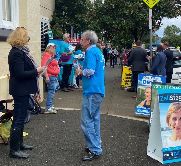 HOW TO VOTE: Bridie Nolan (wife of Zali Steggall's ex-husband) works for Katherine Deves outside a polling booth. Picture: Kate Cox