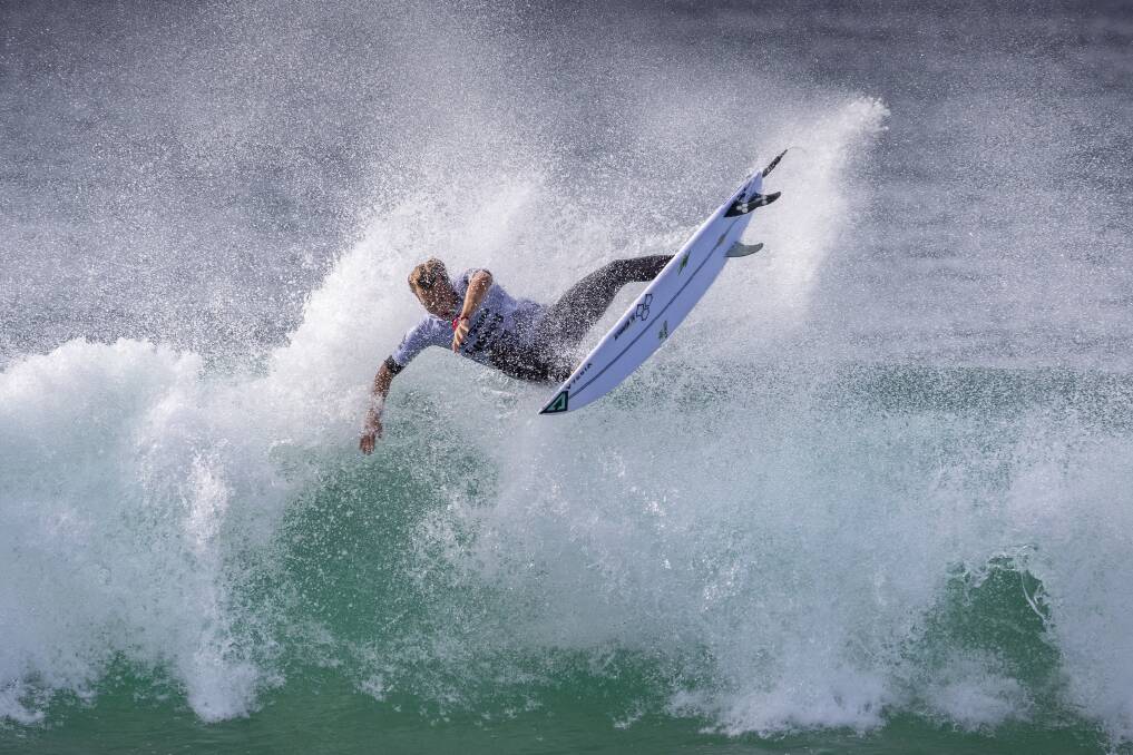 ANNOYED: Local Jordan Lawler winning his Sydney Surf Pro opening heat at Manly. Left, local Saxon Reber. Pictures: Dallas Kilponen