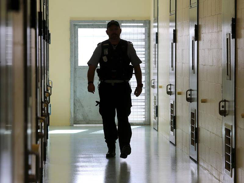 Tasmania's government must ensure potentially harmful prison lockdowns are reduced, a report says.