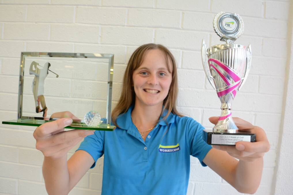 Quedesha Golledge proudly displays her ACT Week of Golf girls and girls 16 years and over trophies. Photo: Scott Calvin.