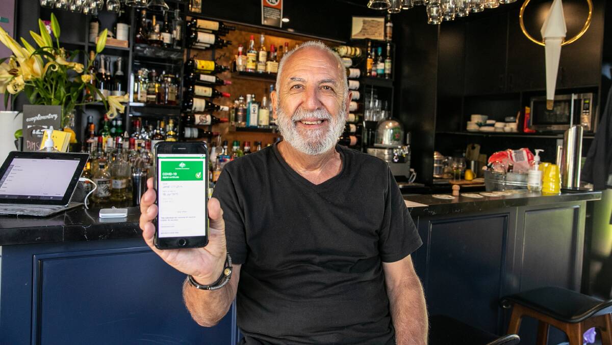 PASSPORT TO FREEDOMS: Mrs Robertson Wine Bar owner Michael Patching is surprised at how seamless the vaccine passport rollout has been. Picture: Geoff Jones