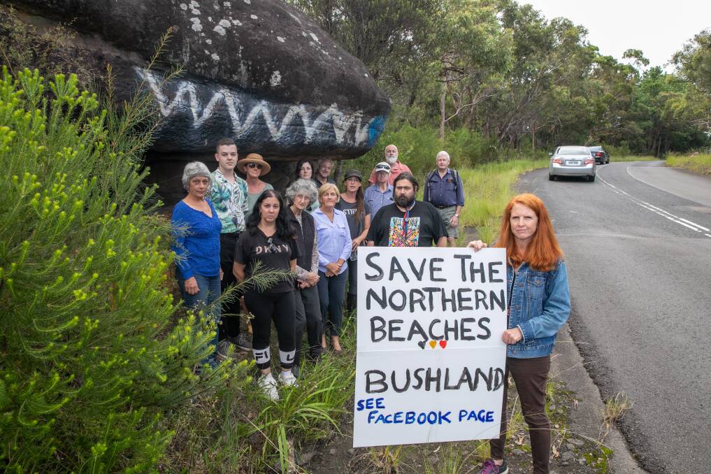 NOT HERE: Resident Nicole Romain with other concerned community members at the site where 450 homes could be built in Belrose. Picture: Geoff Jones