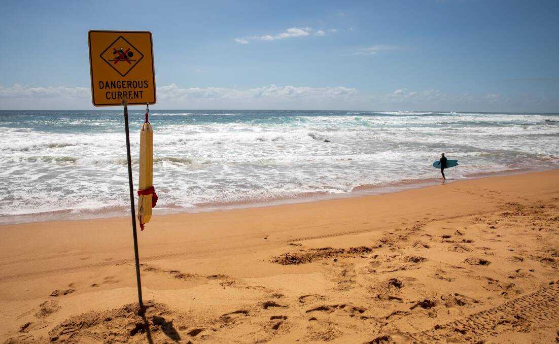 BIG SWELL: Dangerous current signs remained up the day after a man was pulled unconsious from the surf at Newport Beach. Picture: Geoff Jones