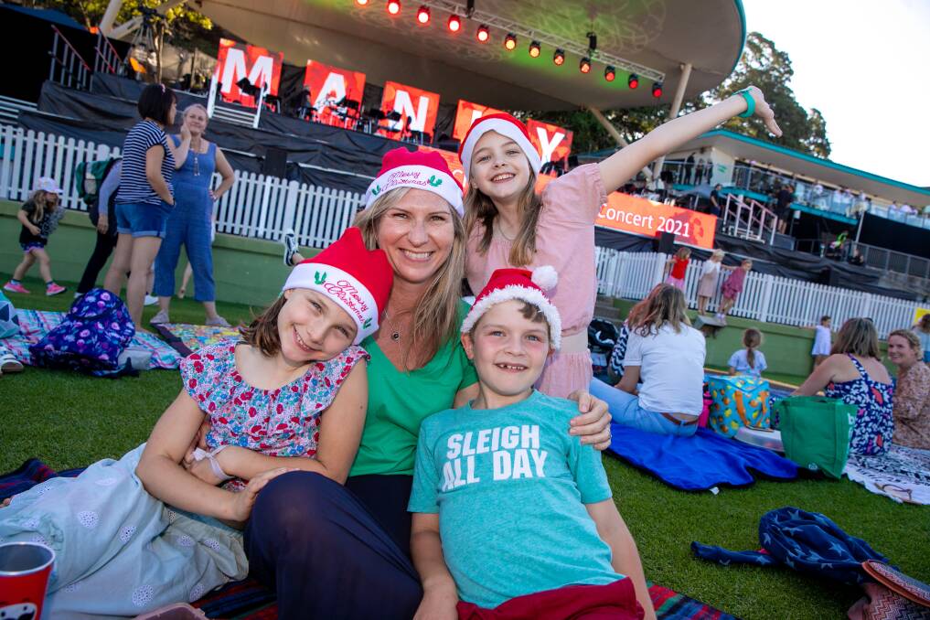 FESTIVE FUN: Sarah Demenis with her children Charlotte and Ollie and friend Issy Baxter at the Christmas Choral Concert at Manly Oval. Picture: Geoff Jones